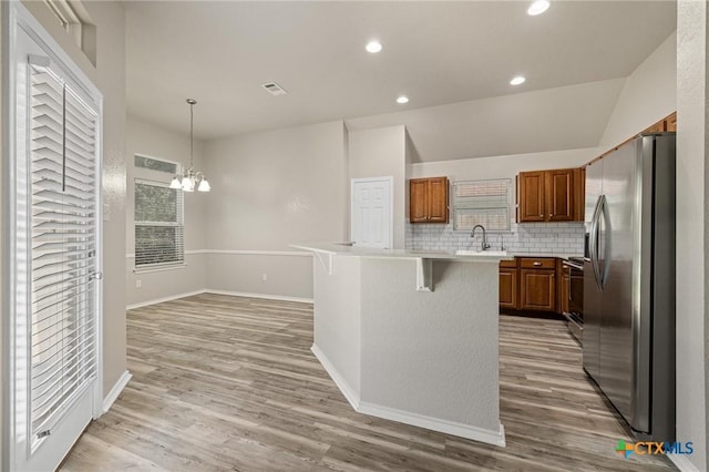 7617 Amber Meadow Loop, Temple, TX 76502 - kitchen with stainless steel refrigerator with ice dispenser, light countertops, a chandelier, decorative backsplash, and a breakfast bar