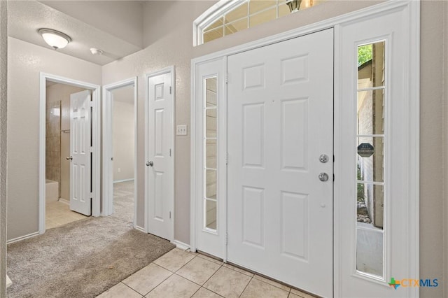 7617 Amber Meadow Loop, Temple, TX 76502 - entryway featuring light tile patterned flooring, light carpet, and baseboards