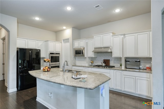 kitchen with appliances with stainless steel finishes, a sink, white cabinets, dark wood-type flooring, and recessed lighting