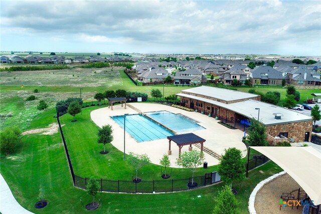 community pool featuring a patio area and a residential view