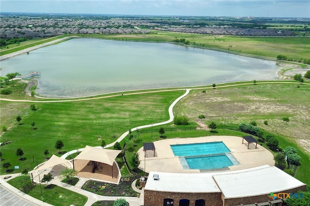 bird's eye view of a nearby body of water and a pool area