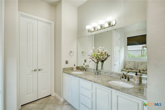 bathroom with tile patterned floors and double vanity