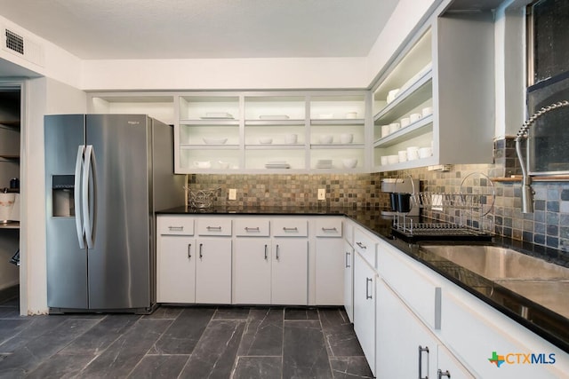 kitchen featuring visible vents, decorative backsplash, stainless steel refrigerator with ice dispenser, marble finish floor, and white cabinetry