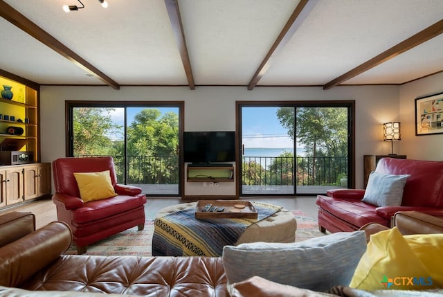 living area with beamed ceiling and a textured ceiling