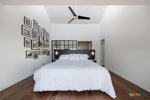 bedroom featuring wood finished floors, baseboards, and ceiling fan