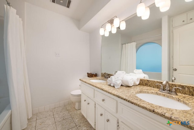 bathroom featuring a sink, visible vents, toilet, and tile patterned flooring