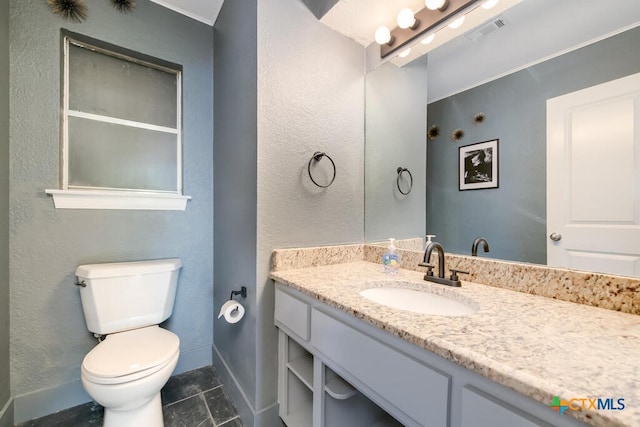 bathroom with visible vents, baseboards, toilet, tile patterned floors, and vanity