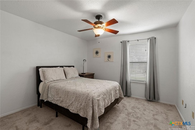 300 Ridge Crest Dr, Seguin, TX 78155 - bedroom featuring light carpet, a ceiling fan, a textured ceiling, and baseboards