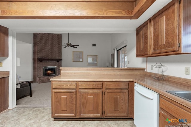 300 Ridge Crest Dr, Seguin, TX 78155 - kitchen featuring dishwasher, a peninsula, a brick fireplace, ceiling fan, and open floor plan
