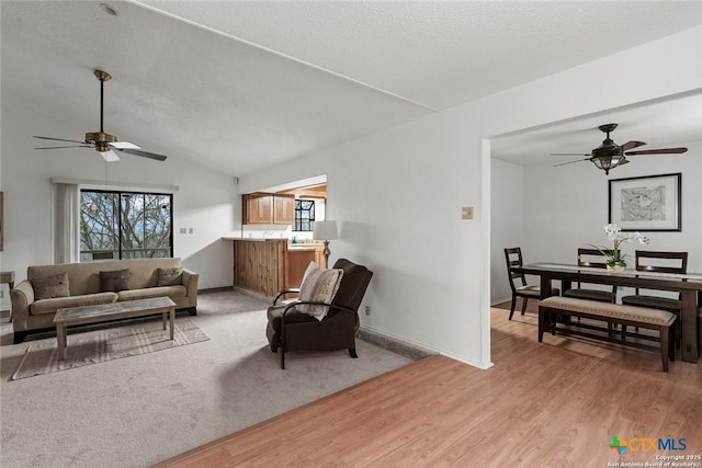 300 Ridge Crest Dr, Seguin, TX 78155 - living room featuring ceiling fan, light wood-type flooring, baseboards, and vaulted ceiling