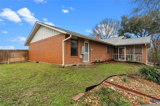300 Ridge Crest Dr, Seguin, TX 78155 - rear view of house with brick siding, a sunroom, a chimney, and board and batten siding