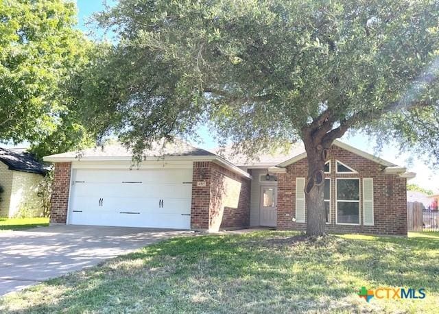 4815 Box Canyon Dr, Temple, TX 76502 - view of front of property featuring brick siding, an attached garage, and driveway