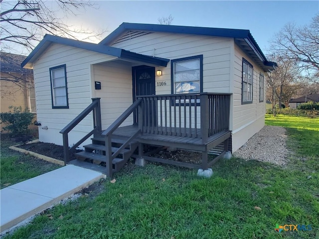 view of front of house featuring a front yard and covered porch