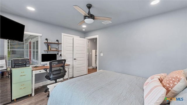 bedroom with ceiling fan and hardwood / wood-style flooring