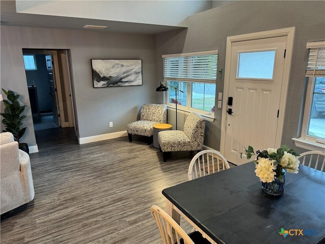 dining space with visible vents, baseboards, and wood finished floors