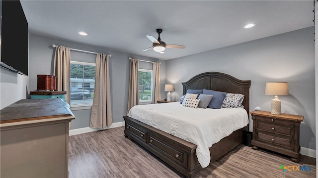 bedroom with light wood-type flooring, ceiling fan, baseboards, and recessed lighting