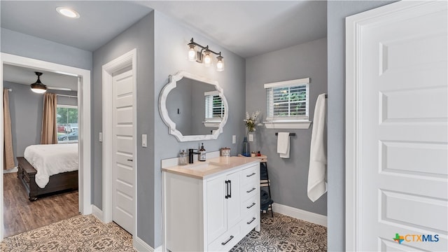 bathroom with a healthy amount of sunlight, tile patterned flooring, and vanity