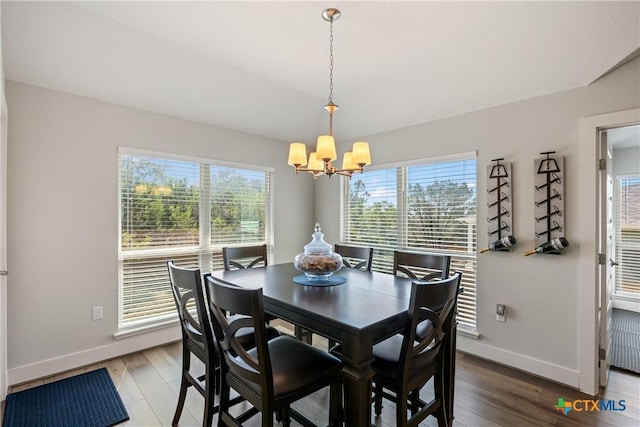 4001 Crockett Ave, Lago Vista, TX 78645 - dining room with baseboards, a chandelier, and wood finished floors