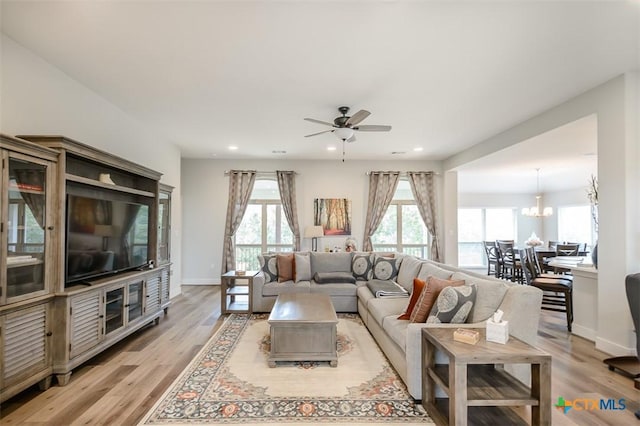 living room with plenty of natural light, light wood-style flooring, and baseboards