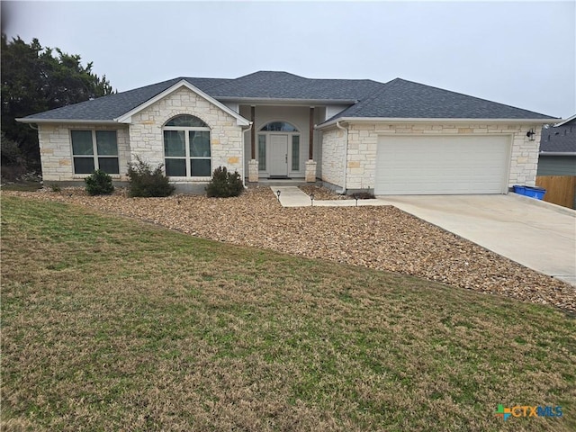 ranch-style home with a garage and a front yard