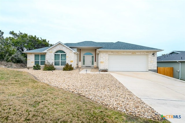 ranch-style house with driveway, a shingled roof, an attached garage, and a front yard