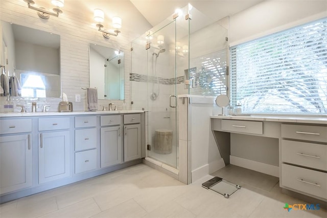 full bathroom with double vanity, a stall shower, tasteful backsplash, tile patterned floors, and a sink