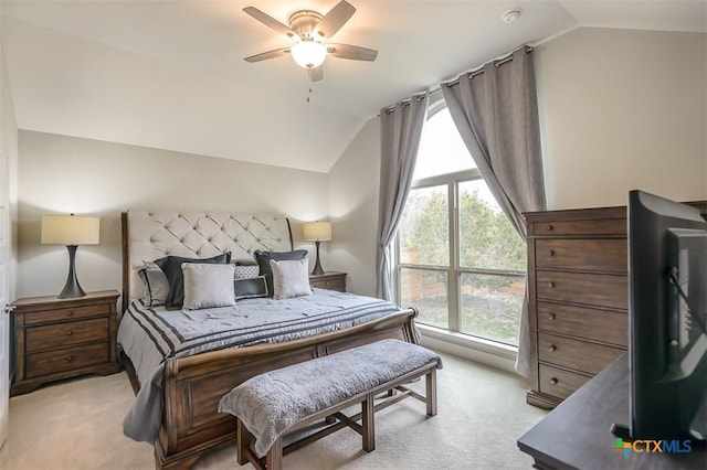 bedroom with light colored carpet, vaulted ceiling, and multiple windows