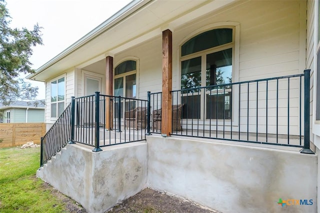 view of exterior entry with a porch