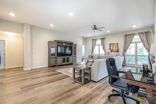 living area with recessed lighting, baseboards, and light wood finished floors