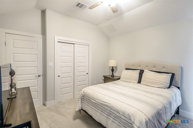 bedroom with light carpet, visible vents, a ceiling fan, vaulted ceiling, and a closet