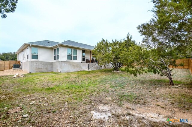 exterior space with a fenced backyard and a lawn