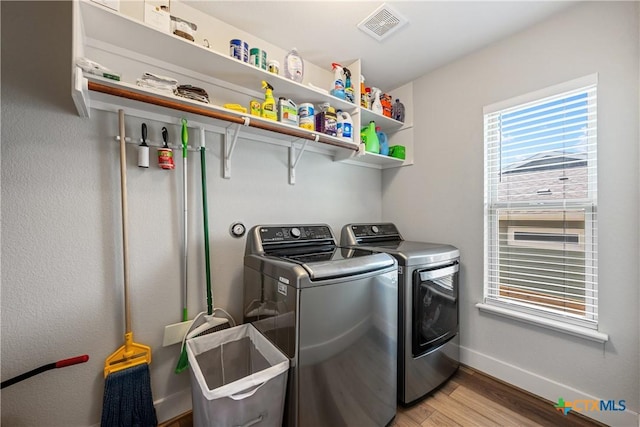 4001 Crockett Ave, Lago Vista, TX 78645 - laundry area featuring separate washer and dryer, light wood-type flooring, and baseboards