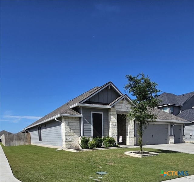 134 Nathaniel Dr, Taylor, TX 76574 - view of front of home with stone siding, a garage, concrete driveway, board and batten siding, and a shingled roof