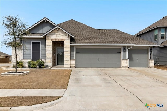 view of front of home featuring stone siding, a garage, concrete driveway, board and batten siding, and roof with shingles