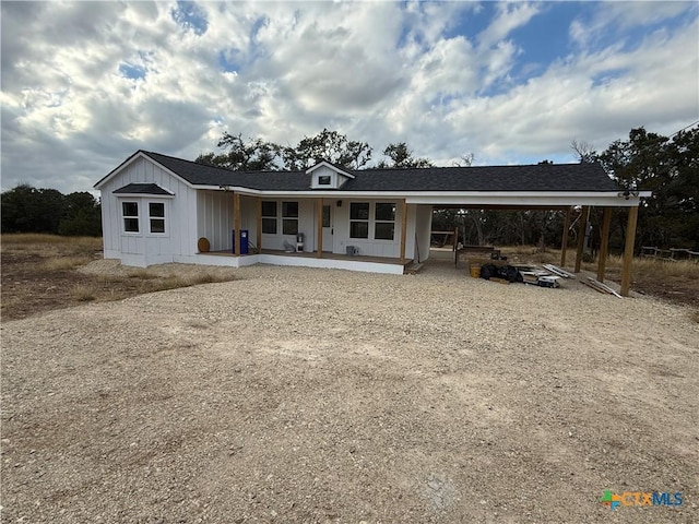1907 Falconwood Dr, San Marcos, TX 78666 - back of property with a carport, covered porch, board and batten siding, and driveway