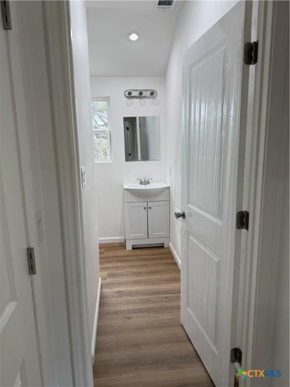 1907 Falconwood Dr, San Marcos, TX 78666 - bathroom with vanity, baseboards, wood finished floors, and recessed lighting