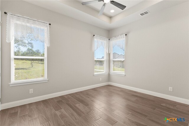 1125 Provence Pl, New Braunfels, TX 78132 - empty room with wood finished floors, a raised ceiling, baseboards, a ceiling fan, and recessed lighting