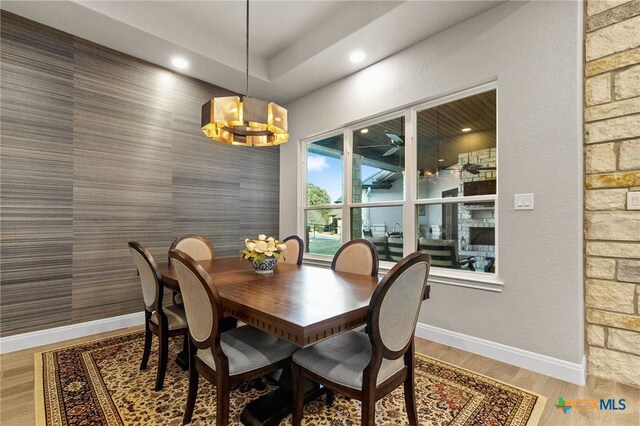 1125 Provence Pl, New Braunfels, TX 78132 - dining room featuring an accent wall, baseboards, a chandelier, light wood-type flooring, and recessed lighting