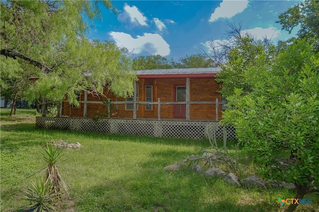 132 Madrona Ln, Bandera, TX 78003 - back of property featuring a porch and metal roof