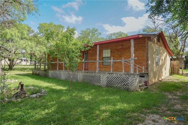 132 Madrona Ln, Bandera, TX 78003 - view of home's exterior featuring covered porch and a yard