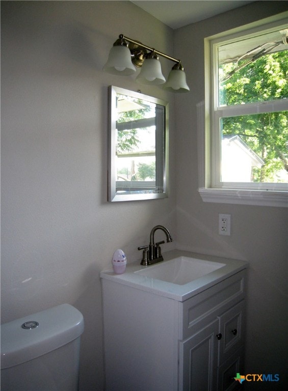 bathroom featuring vanity and toilet