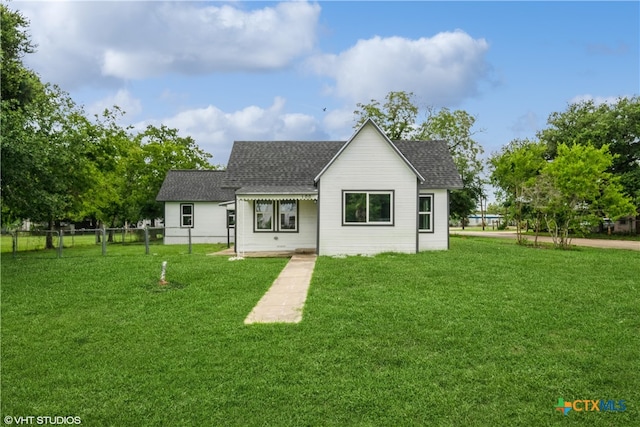 back of property featuring a lawn