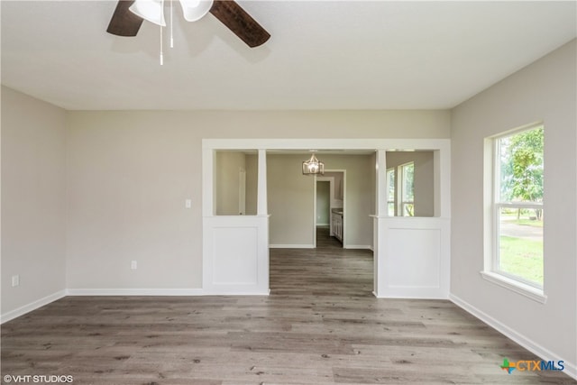 empty room featuring hardwood / wood-style floors, plenty of natural light, and ceiling fan