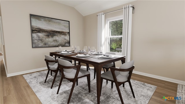 dining room featuring hardwood / wood-style floors and lofted ceiling