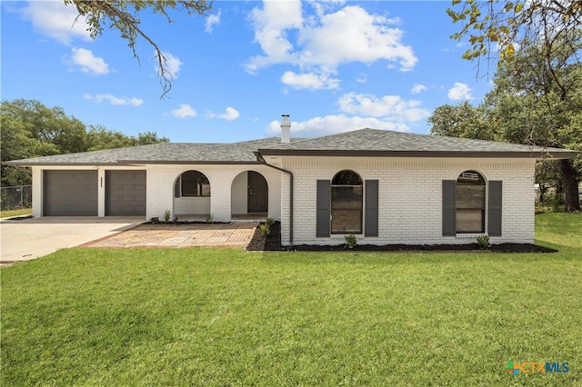 single story home featuring a front lawn, a garage, and a porch