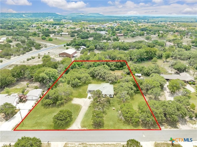 birds eye view of property with a mountain view