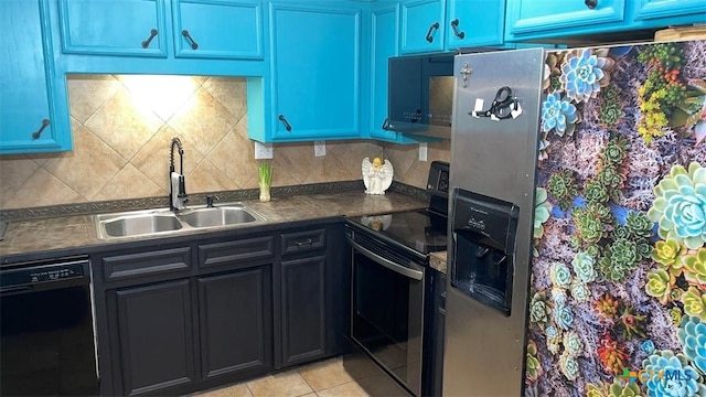kitchen with light tile patterned floors, decorative backsplash, a sink, dark countertops, and black appliances