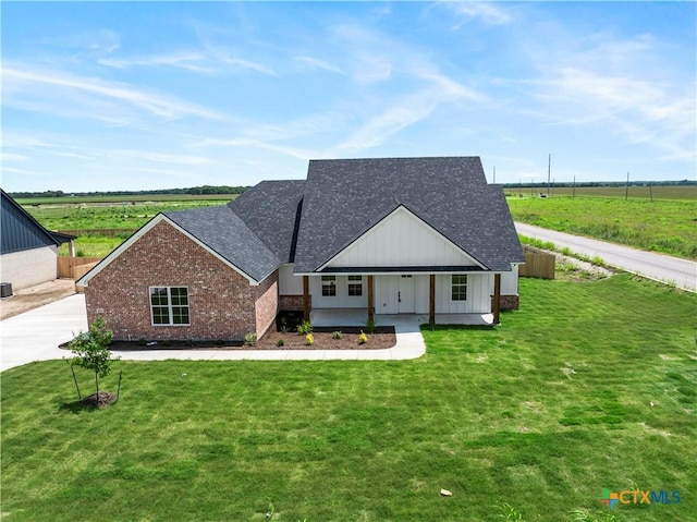 1811 Ember Dr, Temple, TX 76502 - modern inspired farmhouse featuring a shingled roof, brick siding, a front yard, and covered porch