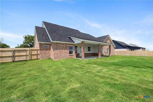 1811 Ember Dr, Temple, TX 76502 - rear view of house with a fenced backyard, brick siding, a patio area, and a shingled roof