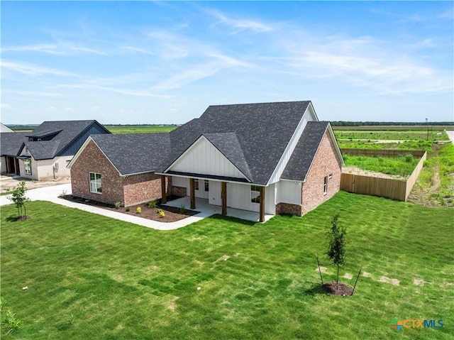 1811 Ember Dr, Temple, TX 76502 - view of front of house with brick siding, a front yard, and a shingled roof